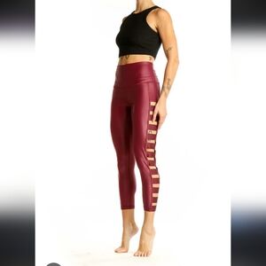 Victoria Sport Knockout High-Waist burgundy leggings with side cutout details. 